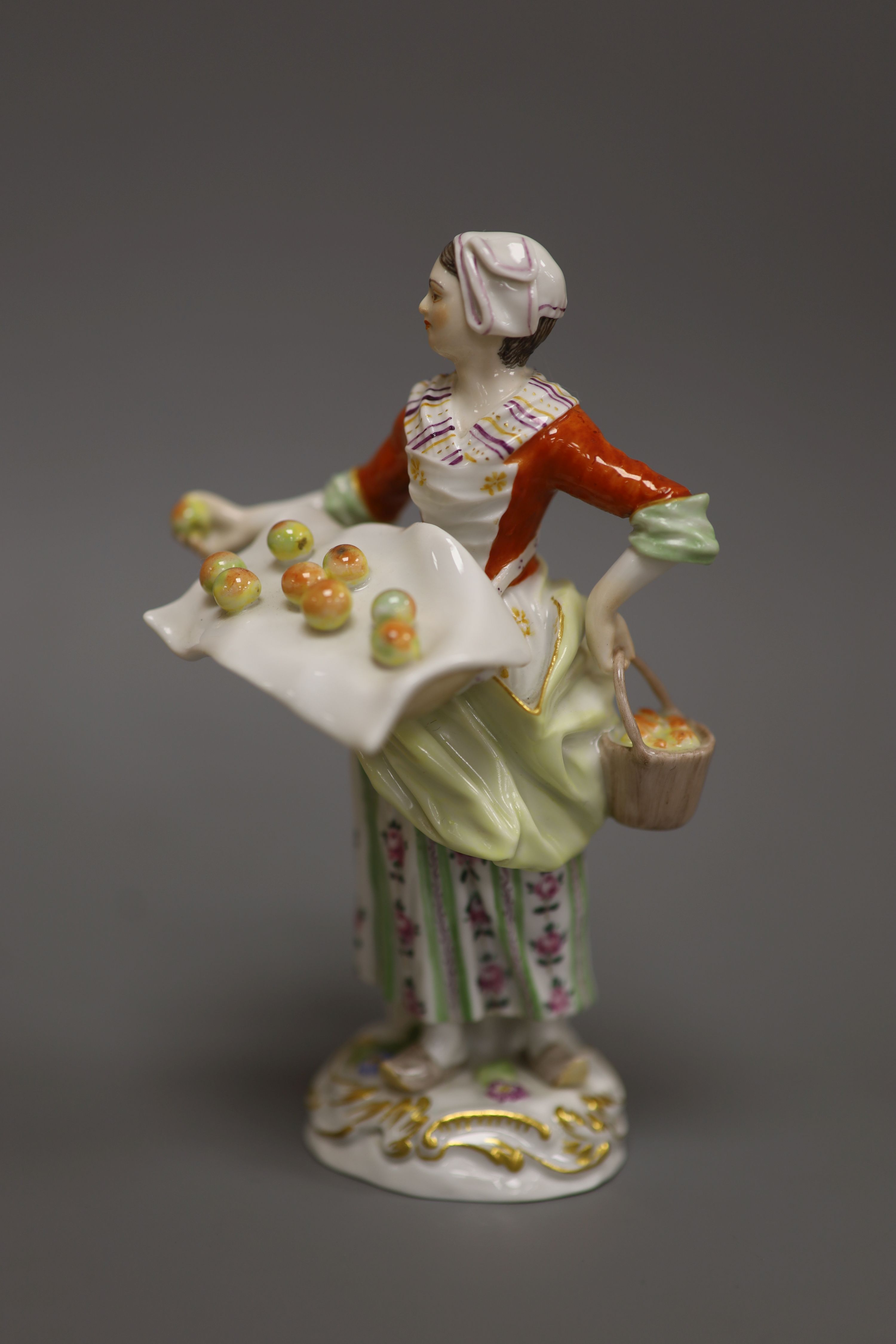A late Meissen porcelain figure of a girl selling apples, H 14cm